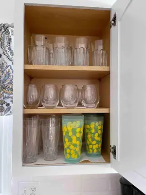 a cupboard filled with clear bowls and vases at Bayview Coastal Home - Steps to Shore & Free Parking in Keansburg