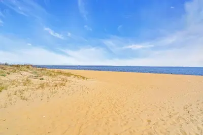 a sandy beach with the ocean in the background at Bayview Coastal Home - Steps to Shore & Free Parking in Keansburg