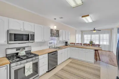 a kitchen with white cabinets and a stove top oven at Bayview Coastal Home - Steps to Shore & Free Parking in Keansburg