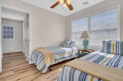 a bedroom with two beds and a ceiling fan at Bayview Coastal Home - Steps to Shore & Free Parking in Keansburg