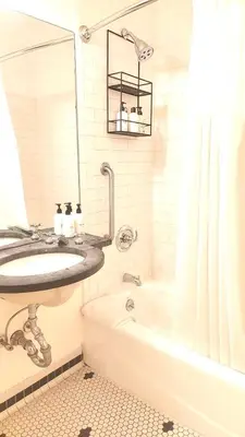 a bathroom with a sink and a bath tub at 414 Hotel in New York