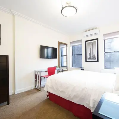 a large bedroom with a large bed and a desk at 414 Hotel in New York