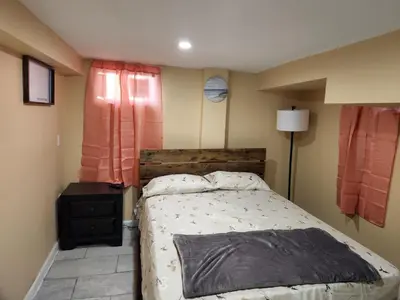 a bedroom with a large bed and a window at 2kings Apartment in Newark