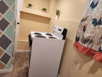 a kitchen with a stove and a refrigerator at 2kings Apartment in Newark