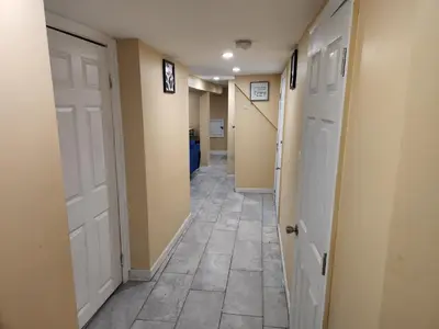 a hallway with two doors and a tile floor at 2kings Apartment in Newark