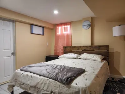 a bedroom with a large bed in a room at 2kings Apartment in Newark