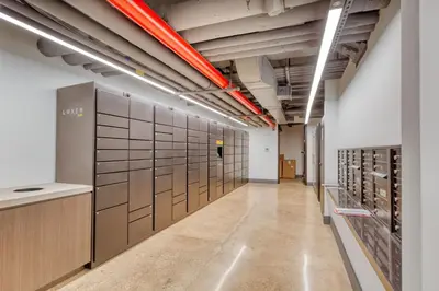 a long hallway with a row of lockers at Blueground Midtown gym AC nr Chrysler NYC-1665 in New York