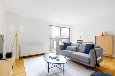 a living room with a couch and a table at Midtown East 1br w elevator nr transport NYC-1249 in New York