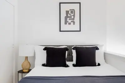 a bedroom with a white bed with black pillows at Midtown East 1br w elevator nr transport NYC-1249 in New York