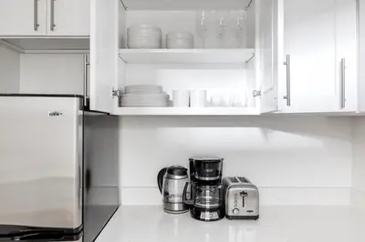 a kitchen counter with white cabinets and appliances at Midtown East 1br w elevator nr transport NYC-1249 in New York