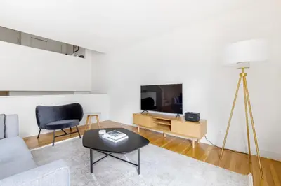 a living room with a couch and a tv at Midtown East 1br w elevator nr transport NYC-1249 in New York