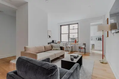 a living room with a couch and a table at Blueground Boerum Hill gym wd nr sports NYC-1573 in New York