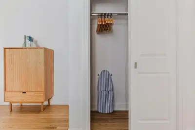 a hallway with a wooden cabinet and a radiator at Blueground Boerum Hill gym wd nr sports NYC-1573 in New York