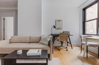 a living room with a couch and a table at Blueground Boerum Hill gym wd nr sports NYC-1573 in New York