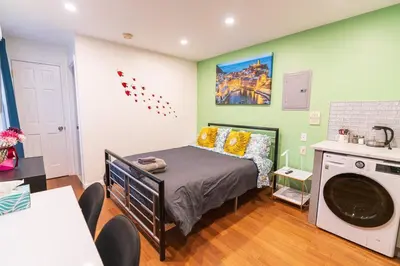 a bedroom with a bed and a washing machine at New! Suite near Rittenhouse Square in Philadelphia