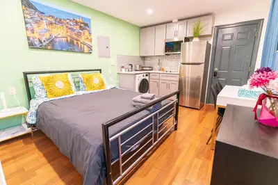 a small room with a bed and a kitchen at New! Suite near Rittenhouse Square in Philadelphia