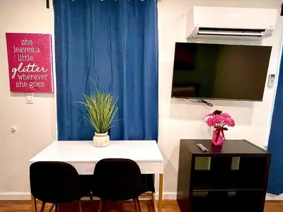 a room with a table and two chairs and a blue curtain at New! Suite near Rittenhouse Square in Philadelphia