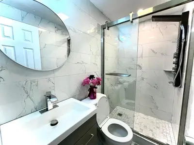 a bathroom with a sink and a toilet and a mirror at New! Suite near Rittenhouse Square in Philadelphia