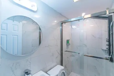 a bathroom with a shower and a toilet and a mirror at New! Suite near Rittenhouse Square in Philadelphia