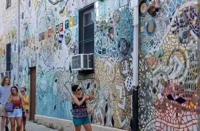 a woman taking a picture of a mural on a building at New! Suite near Rittenhouse Square in Philadelphia