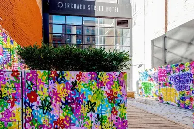 a colorful fence in front of a building at Orchard Street Hotel in New York