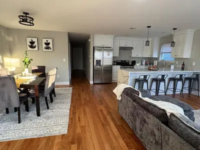 a living room and kitchen with a couch and a table at Near New York-EWR-JG Mall-Train - Elizabeth NJ in Elizabeth