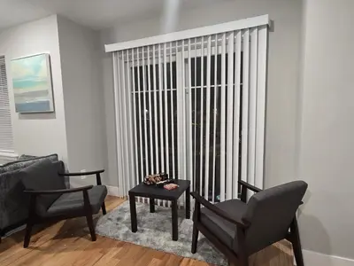 a living room with two chairs and a table and a window at Near New York-EWR-JG Mall-Train - Elizabeth NJ in Elizabeth