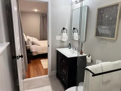 a bathroom with a sink and a toilet and a mirror at Near New York-EWR-JG Mall-Train - Elizabeth NJ in Elizabeth