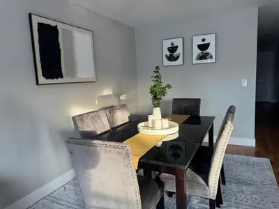 a dining room with a black table and chairs at Near New York-EWR-JG Mall-Train - Elizabeth NJ in Elizabeth