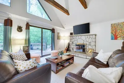 a living room with leather furniture and a fireplace at Pocono Cabin Fireplace Near Skiing Tubing Parks Shopping Casinos Hot Tub Walk to Lake in Pocono Lake
