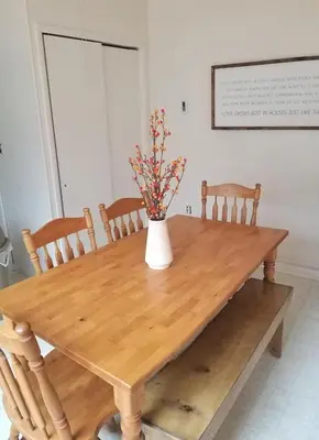 a wooden table with a vase with flowers on it at Pocono Cabin Fireplace Near Skiing Tubing Parks Shopping Casinos Hot Tub Walk to Lake in Pocono Lake
