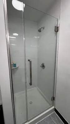 a shower with a glass door in a bathroom at Private Bedroom with Dedicated Bathroom 15mis NYC in West New York