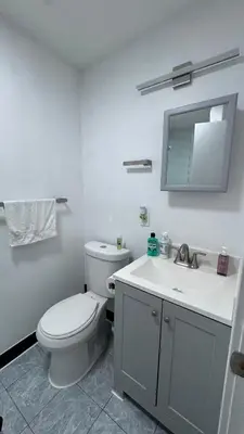 a white bathroom with a toilet and a sink at Private Bedroom with Dedicated Bathroom 15mis NYC in West New York