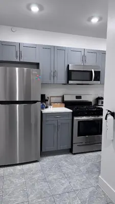 a kitchen with a stainless steel refrigerator and appliances at Private Bedroom with Dedicated Bathroom 15mis NYC in West New York