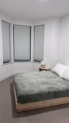 a bedroom with a bed and four windows at Private Bedroom with Dedicated Bathroom 15mis NYC in West New York