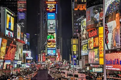 a busy city street at night with many signs at 1A Prime Area Near NYC and EWR 98 Walk score in Newark