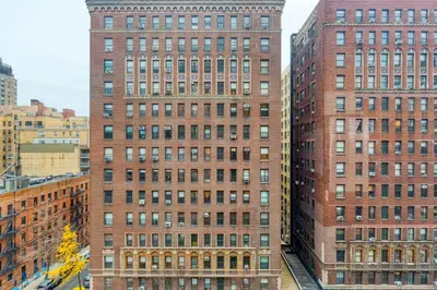 two tall red brick buildings in a city at UWS 1br w gym doorman elevator nr Central Park NYC-1049 in New York