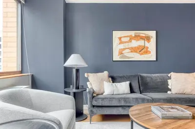 a living room with a gray couch and a table at UWS 1br w gym doorman elevator nr Central Park NYC-1049 in New York