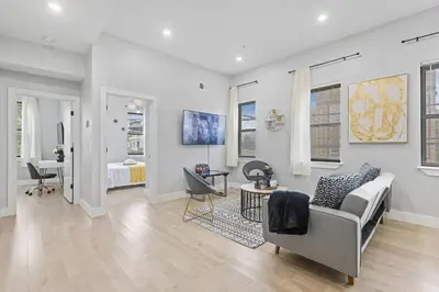a living room with a couch and a bedroom at 2C - Parking Cred, Early CI, King Bed, Sleeps 6 - 30mins to NYC in Newark