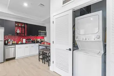 a kitchen with a white refrigerator and a table at 2C - Parking Cred, Early CI, King Bed, Sleeps 6 - 30mins to NYC in Newark