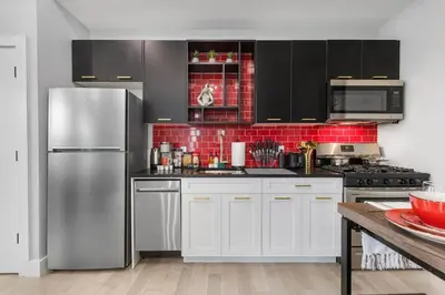 a kitchen with white cabinets and a stainless steel refrigerator at 2C - Parking Cred, Early CI, King Bed, Sleeps 6 - 30mins to NYC in Newark