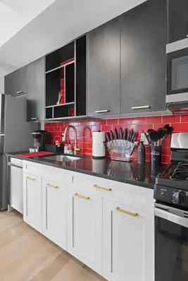 a kitchen with white cabinets and black appliances at 1C - Ask About 20Off - Sleeps 5 - Airport 8min - NYC 30min in Newark