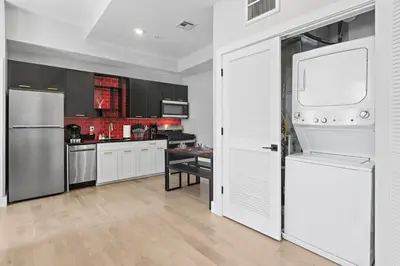 a kitchen with white cabinets and a white refrigerator at 1C - Ask About 20Off - Sleeps 5 - Airport 8min - NYC 30min in Newark