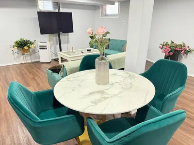 a dining room with a table and green chairs at Cozy 1 bedroom close to NYC with private bar in North Bergen