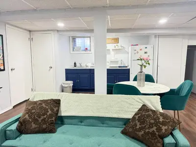 a living room with a couch and a table at Cozy 1 bedroom close to NYC with private bar in North Bergen