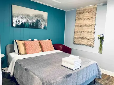 a bedroom with a bed with blue walls at Rittenhouse Square close by Kimmel Center Suite in Philadelphia