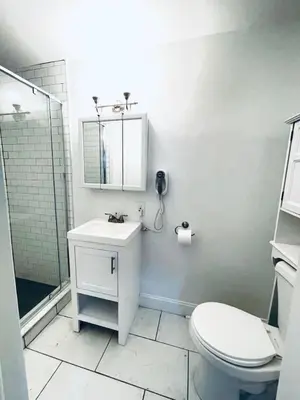 a white bathroom with a sink and a toilet at Rittenhouse Square close by Kimmel Center Suite in Philadelphia