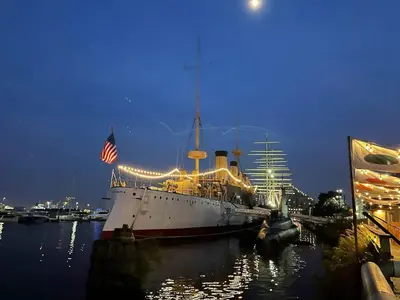 a large ship docked in the water at night at Rittenhouse Square close by Kimmel Center Suite in Philadelphia