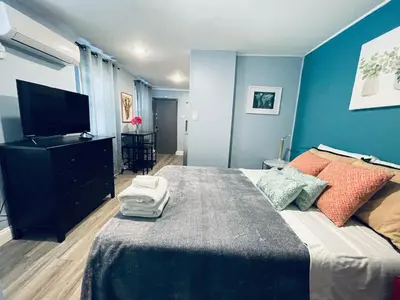 a bedroom with a large bed and a television at Rittenhouse Square close by Kimmel Center Suite in Philadelphia