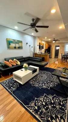 a living room with a couch and a table on a rug at Modern Cozy Huge Balcony in Heart of Passyunk in Philadelphia